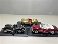 3 DieCast Cars on Stands