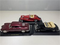 3 DieCast Cars on Stands
