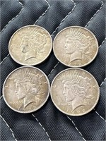 Four 1922 Peace silver dollars