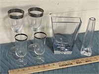 Silver rimmed wine glasses, and two glass vases