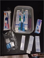 Box of new toothbrushes toothpaste and floss