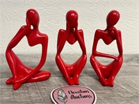 3 small cute red human body figures