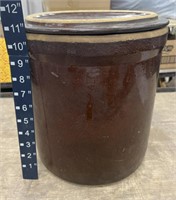 Brown crock with lid. Has a few flaws as