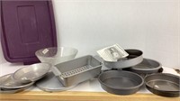 Purple tub of baking pans, some newer, fry pan,