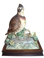 large porecelain bisque quail on a wood stand