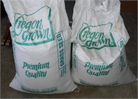 2 50 lb bags grass seed 1 full 1 is 1/2 full
