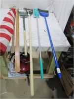 flag, brooms, rake, cleaning items