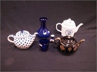 Six blue items including three teapots,