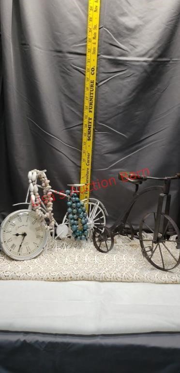 Antique looking bike with a clock. Antique