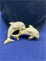 Gold tone dolphin brooch