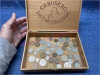 Foreign coins in wood cigar box