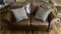 Brown leather love seat w 4 pillows