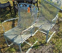 2 Green Metal Patio Chairs. Outside In Gated Yard
