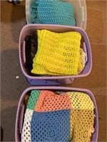 Four totes of crocheted blankets