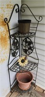 51" tall metal corner plant stand with contents,
