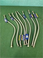Eight stainless steel plumbing connectors,