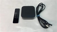 Apple TV box with power cable and controller
