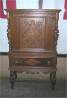 Antique walnut curio cabinet heavily carved