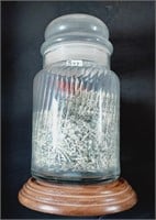 8" tall  glass jar with shredded currency