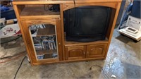 Oak entertainment center includes TV and DVDs and