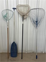 Assortment of Fishing Nets and an Oar