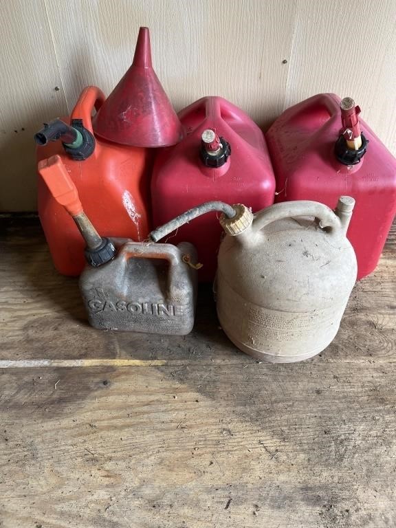 Assortment of 5 plastic gas cans and 1 funnel
