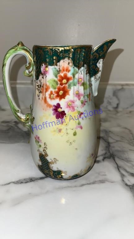 Vintage flowers pitcher. Crack