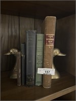 Brass bookends and vintage hardback books