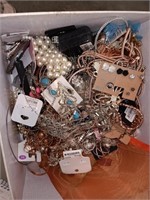 Box of unsorted jewelry , pins , necklaces ,