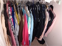 Top rack of clothes in the closet.