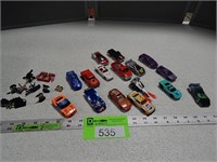 Assorted toy vehicles; small action figures
