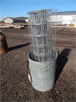 Small galvanized garbage can and a partial roll of