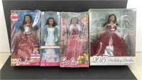 Lot of 4- boxed Barbie dolls