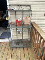 Outdoor plant stand with flowerpots and figurines