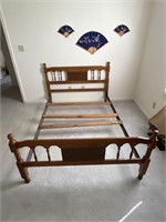 Full size bed with wooden headboard and footboard