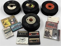 assortment of old 45s and old cassette tapes,