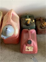 4 gas cans and a funnel one gas can has been