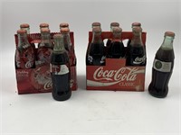 Assortment of unopened Coca-Cola bottles 7