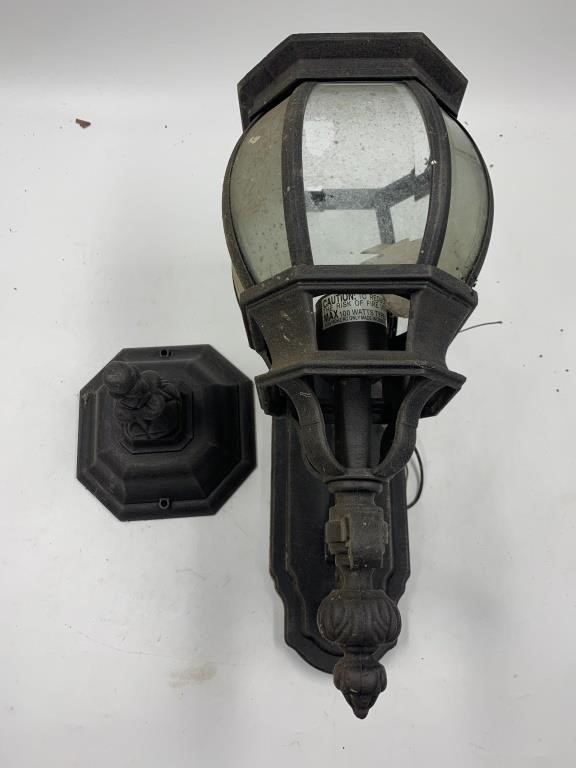 Black metal wall mount outdoor light with storm
