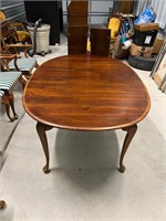 Solid wood dining table with two leaves