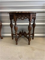 Small, solid wood table very ornate