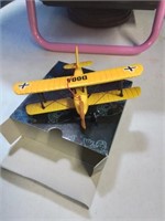 Small yellow wooden biplane missing wheel inside