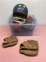 Vintage baseball gloves, helmet and balls