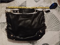Black coach purse Has a tarnished spot on the