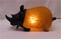 Rhinoceros decorator lamp w/ amber glass shade,