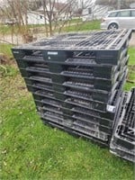 Stack of 11  plastic pallets