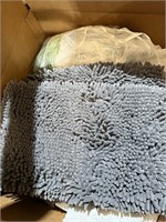 large box of new homegoods, rugs, linens, etc
