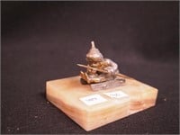 Metal figure on marble stand of boy on sled