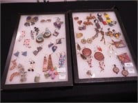 Two containers of pierced earrings including