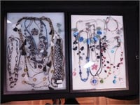 Two containers of costume jewelry including